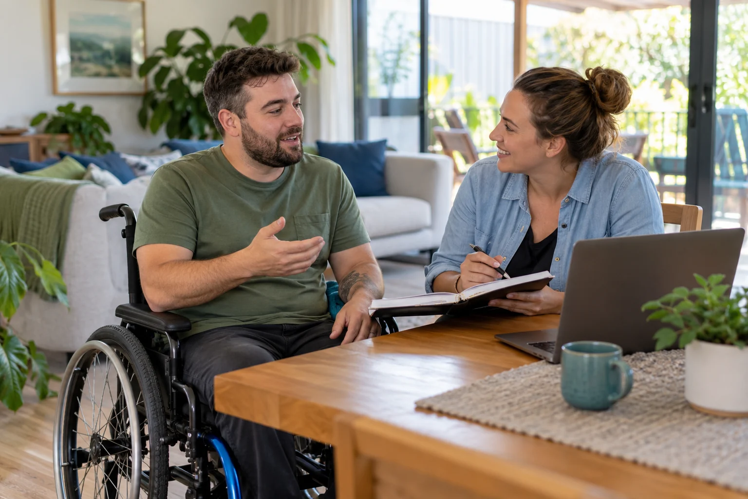 A man using a wheelchair discusses a plan with a companion at home