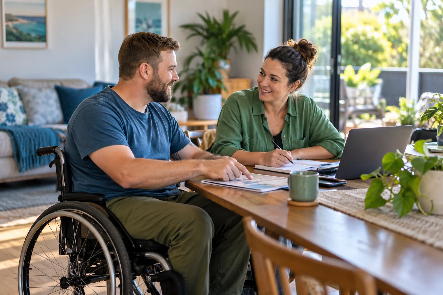 A man using a wheelchair discusses a plan with a companion at home