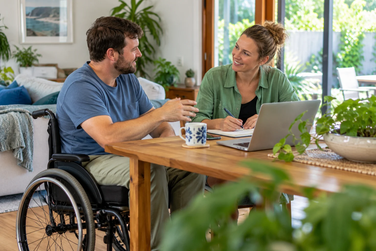 A man using a wheelchair discusses a plan with a companion at home
