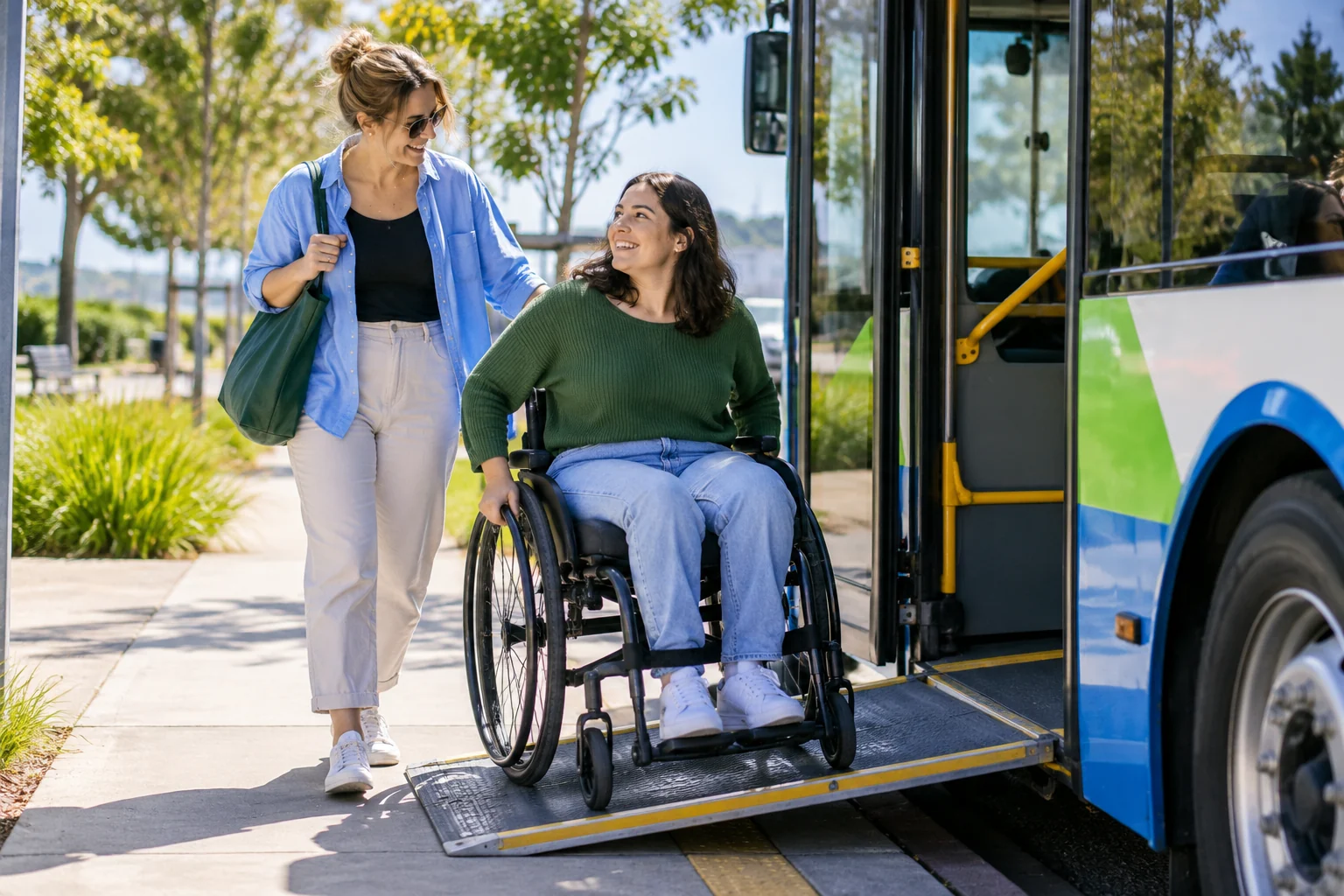 A woman using a wheelchair and a companion near an accessible bus